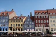 Charming historical buildings with vibrant colors line the famous Nyhavn waterfront in Copenhagen, Denmark.